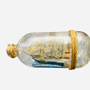 vintage ship in a bottle, with a miniature sailing vessel
